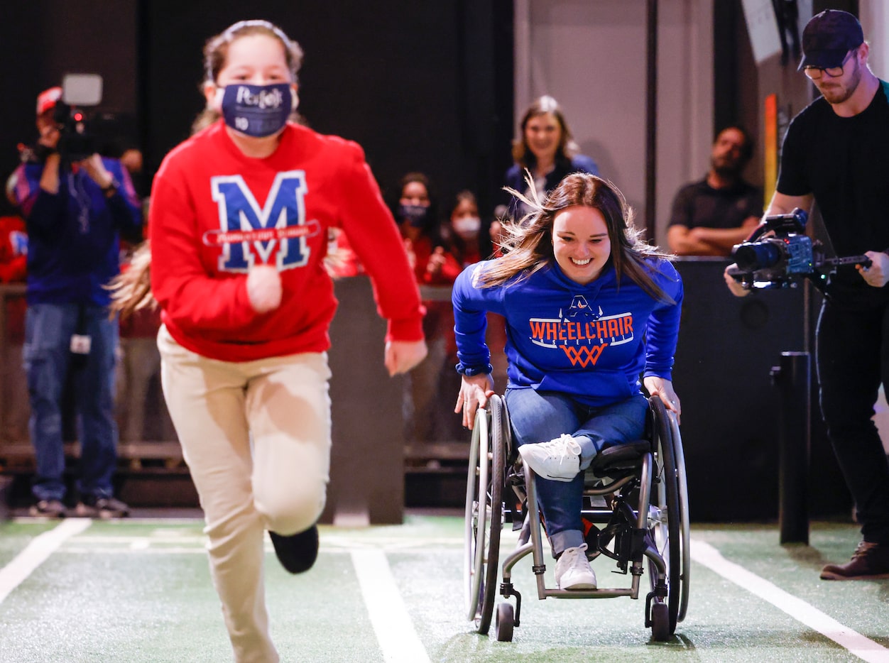 Paralympian Élodie Tessier, right, tries to catch up Momentous School fifth grader Yuliana...