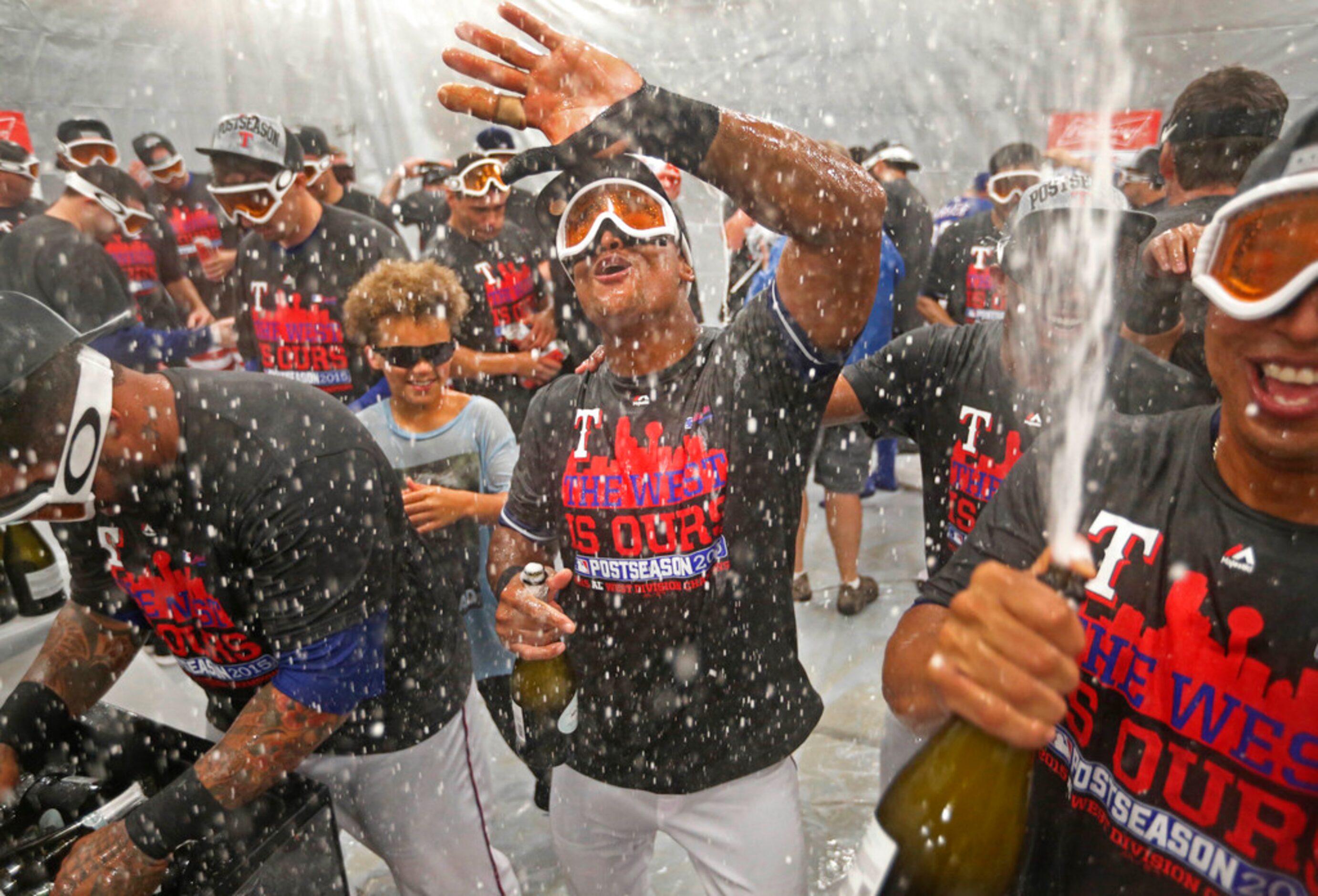 Texas Rangers players, including Adrian Beltre (center), dance together in the locker room...