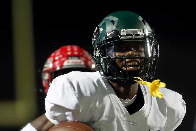 DeSoto defensive back Ashton Levells-Mitchell (15) sprints to the end zone for a touchdown...