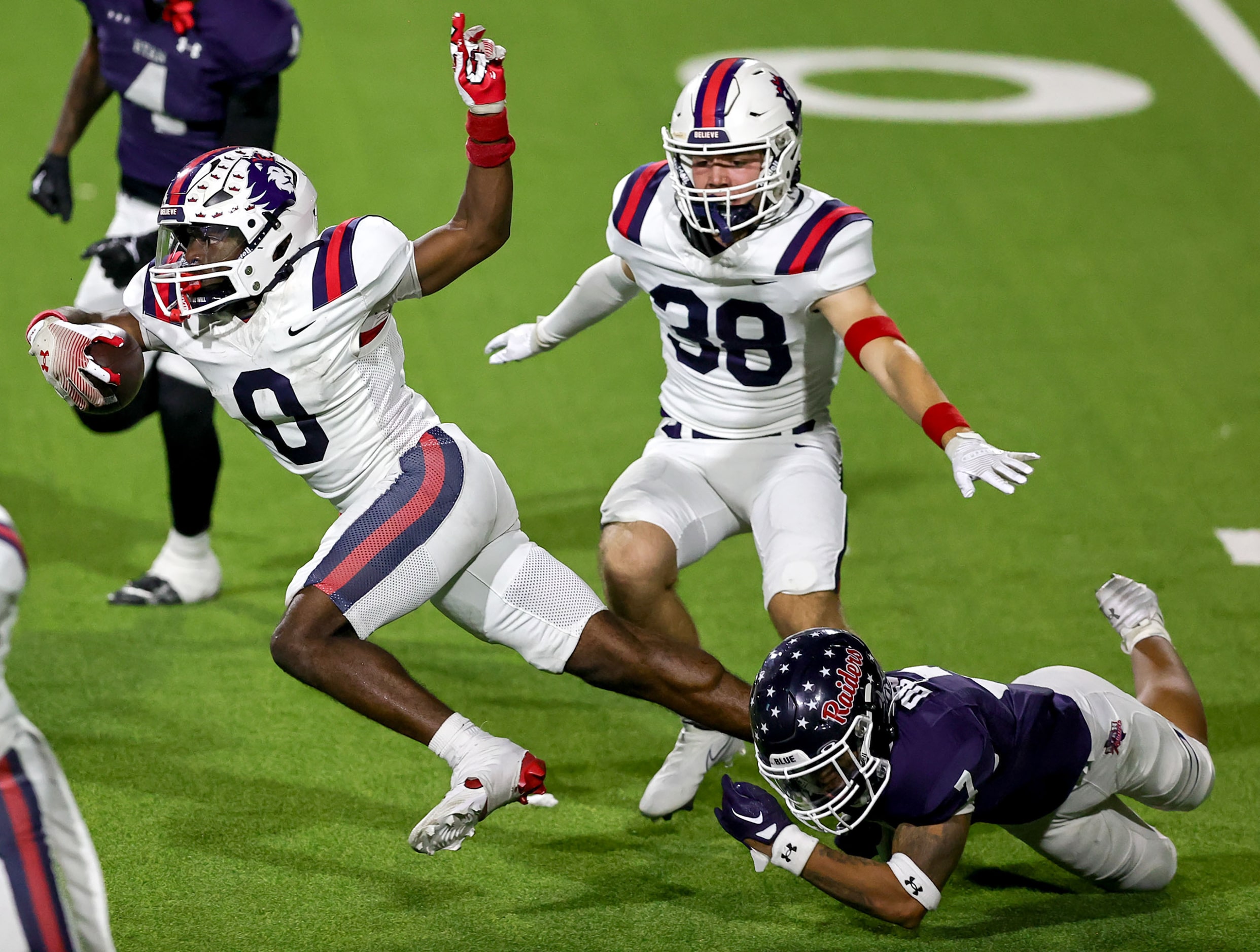 Richland kickoff returner Jaylen Gordon (0) gets tripped up by Denton Ryan's Jaxson Dozier...