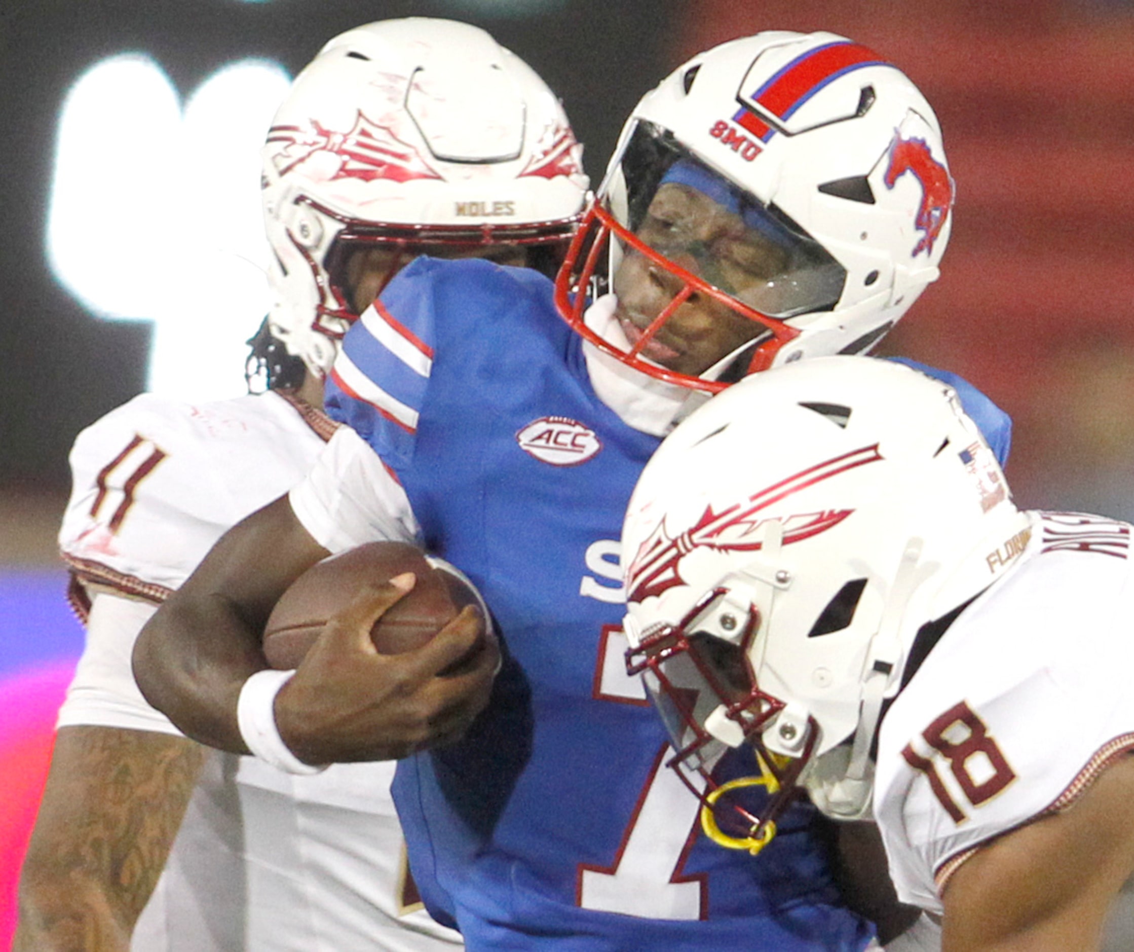 SMU Mustangs quarterback Kevin Jennings (7), center, is stopped after a short rushing gain...