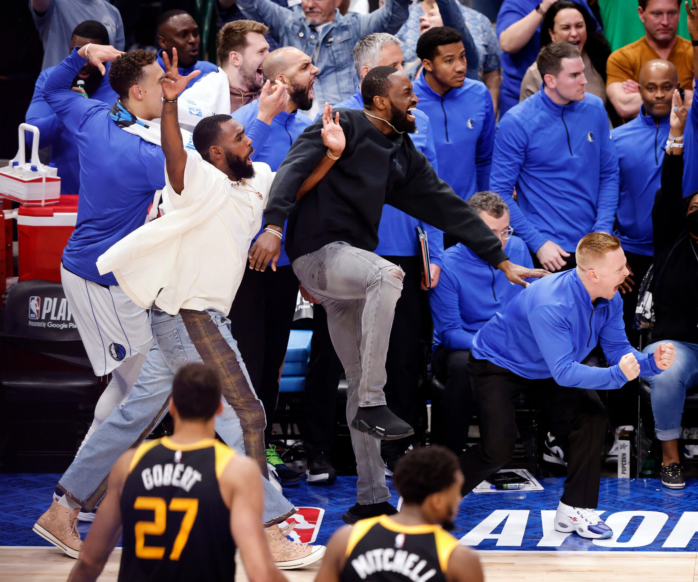 The Dallas Mavericks bench erupts in celebrations after forward Maxi Kleber (right) nailed a...