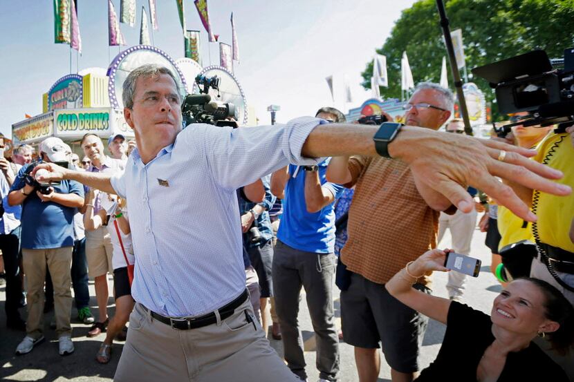 Republican presidential candidate, former Florida Gov. Jeb Bush, throws a baseball on the...