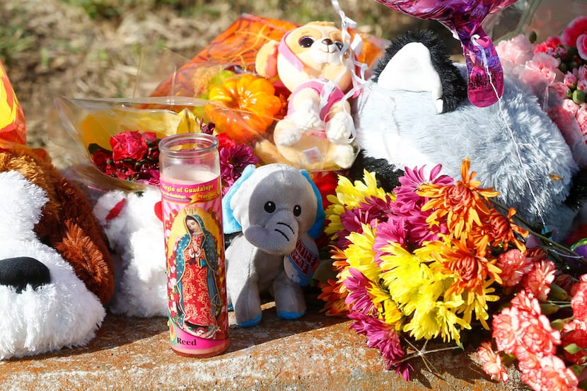 Stuffed animals and candles mark the ditch where the body of Sherin Mathews was found. 