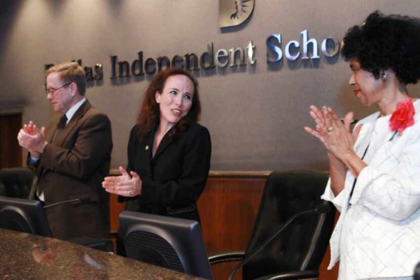 Interim Superintendent Alan King and Carla Ranger (right) applauded new trustees Elizabeth...