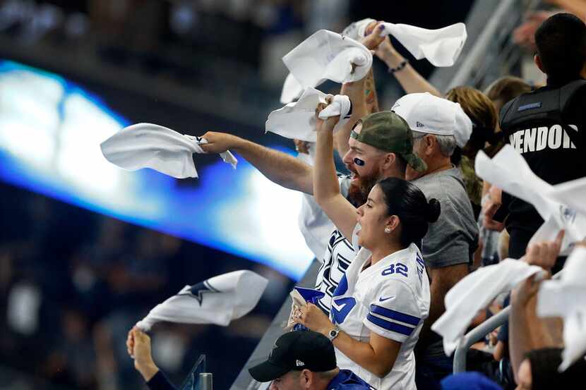 Dallas Cowboys fans wave their spirit towels before the season opener against the New York...