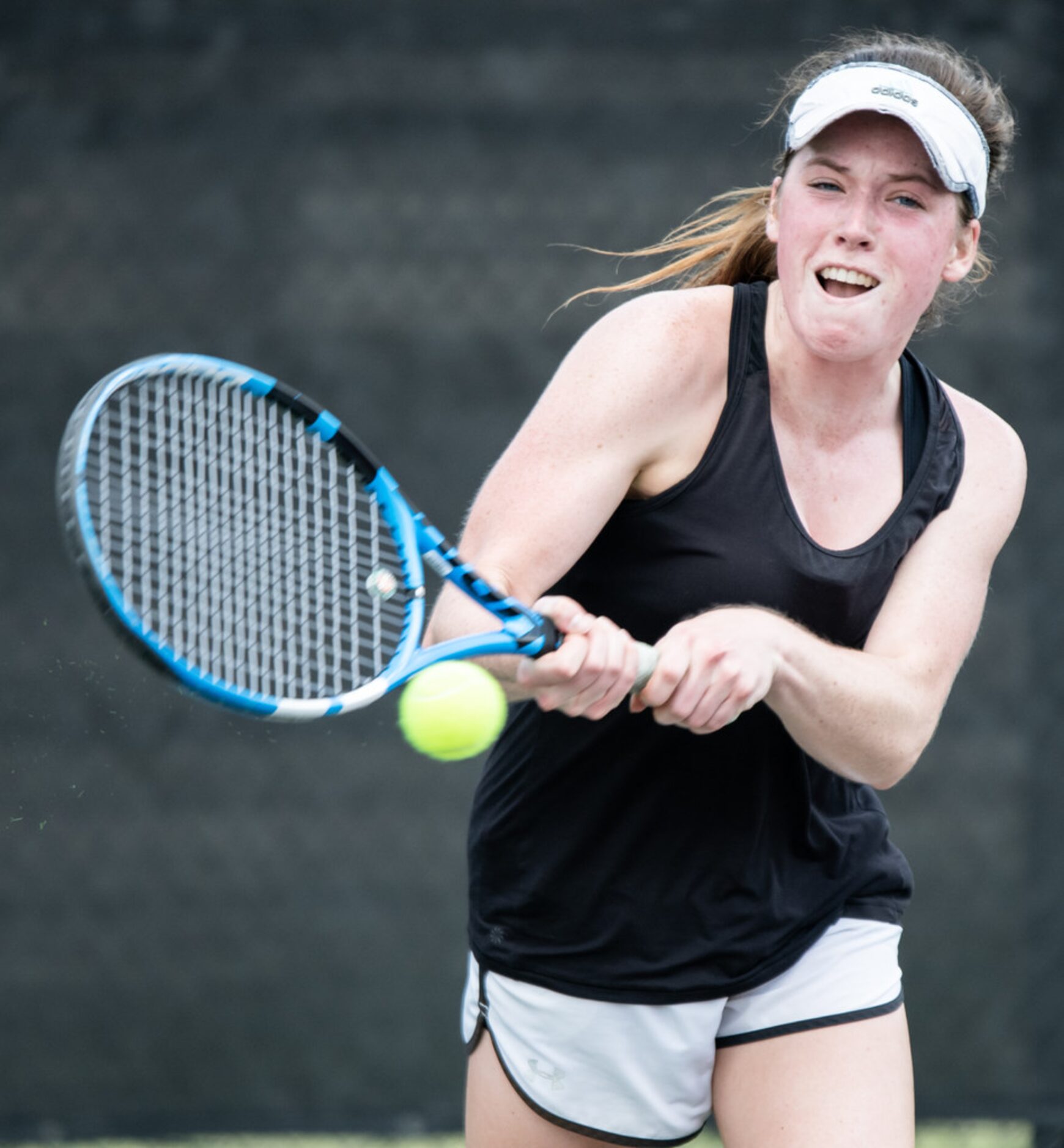 Southlake Carroll's Samantha Lowe returns the ball in a doubles match with teammate Brennan...