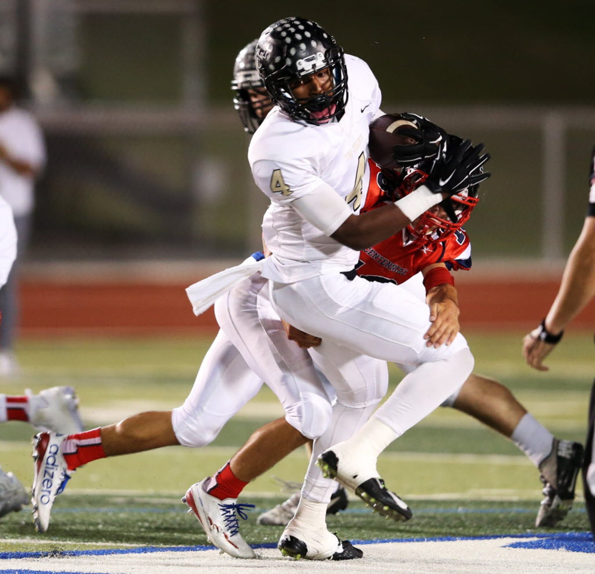 The Colony's Khalil Banks (4) is tackled by Frisco Centennial's Jacob Morrow (18) during the...