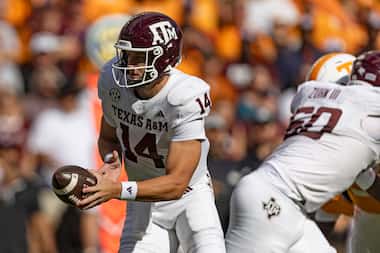 Texas A&M quarterback Max Johnson (14) turns to hand the ball off during the first half of...