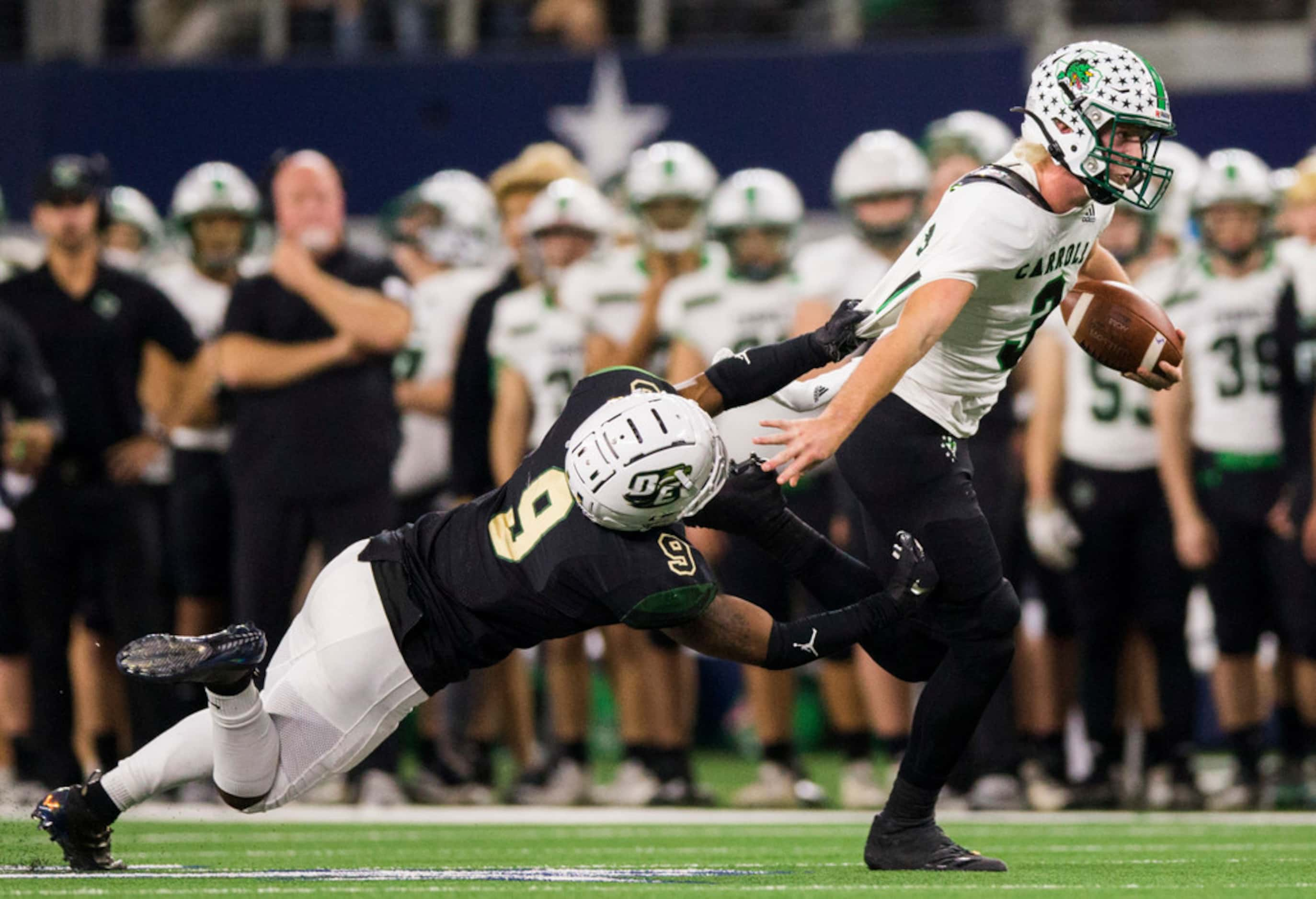 Southlake Carroll quarterback Quinn Ewers (3) is pulled down by DeSoto linebacker Ridarius...