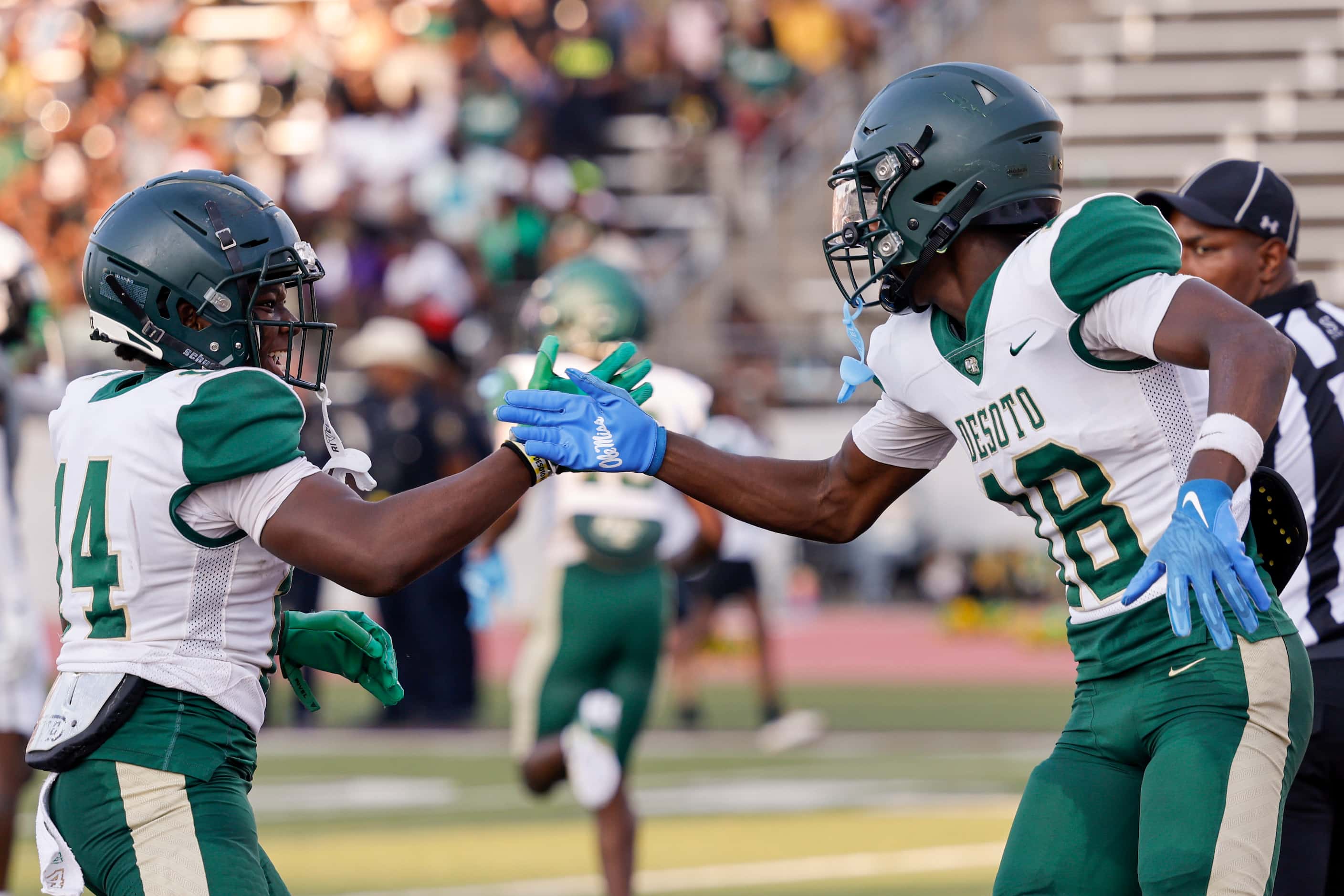 DeSoto wide receiver Ethan Feaster (18) celebrates his touchdown with wide receiver Tristan...