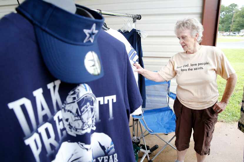 Charlotte Harlan shops for Dallas Cowboys quarterback Dak Prescott items at a car wash less...