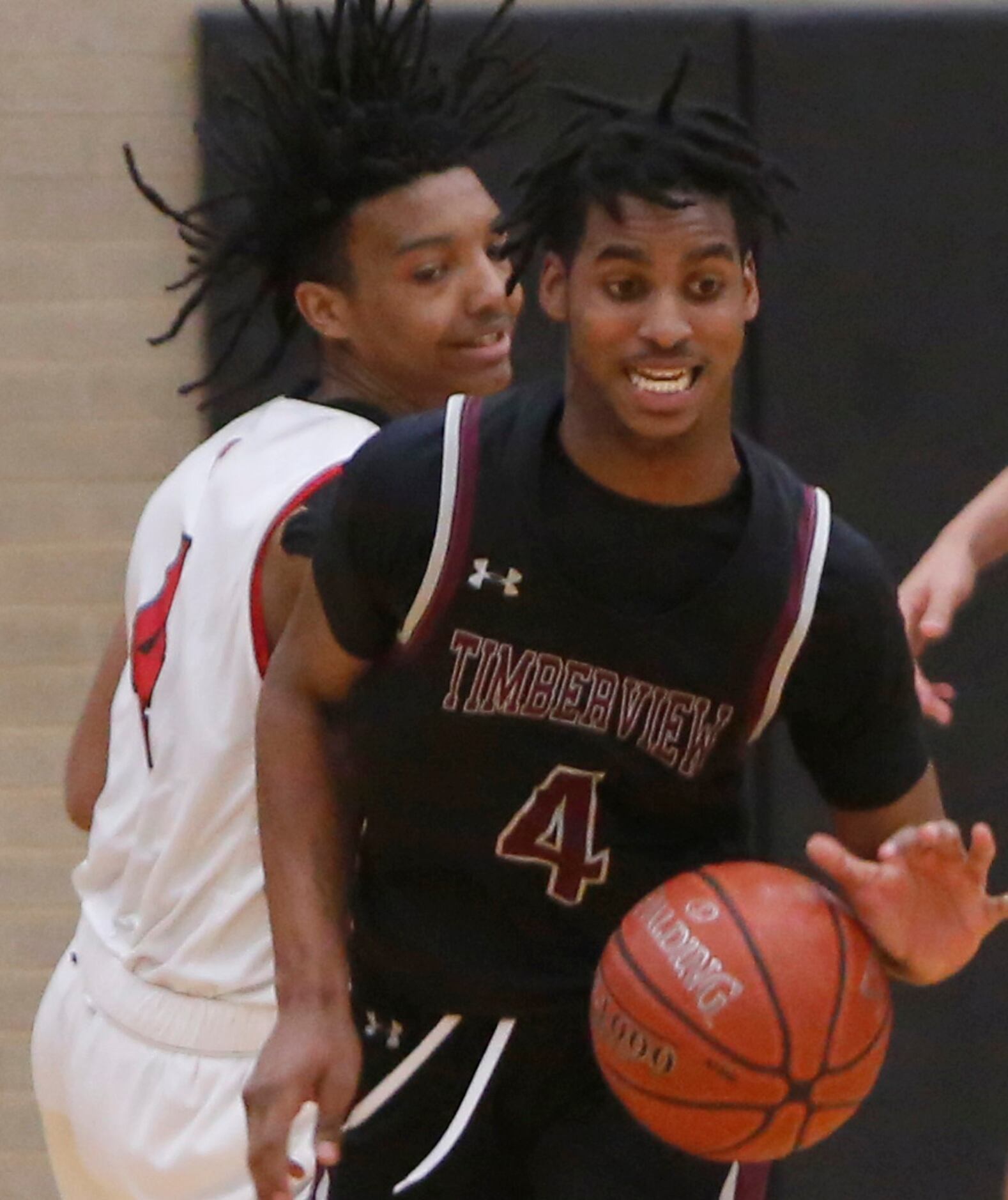 Mansfield Timberview guard Eyan Gooden (4) wrestles the ball away from Mansfield Legacy...