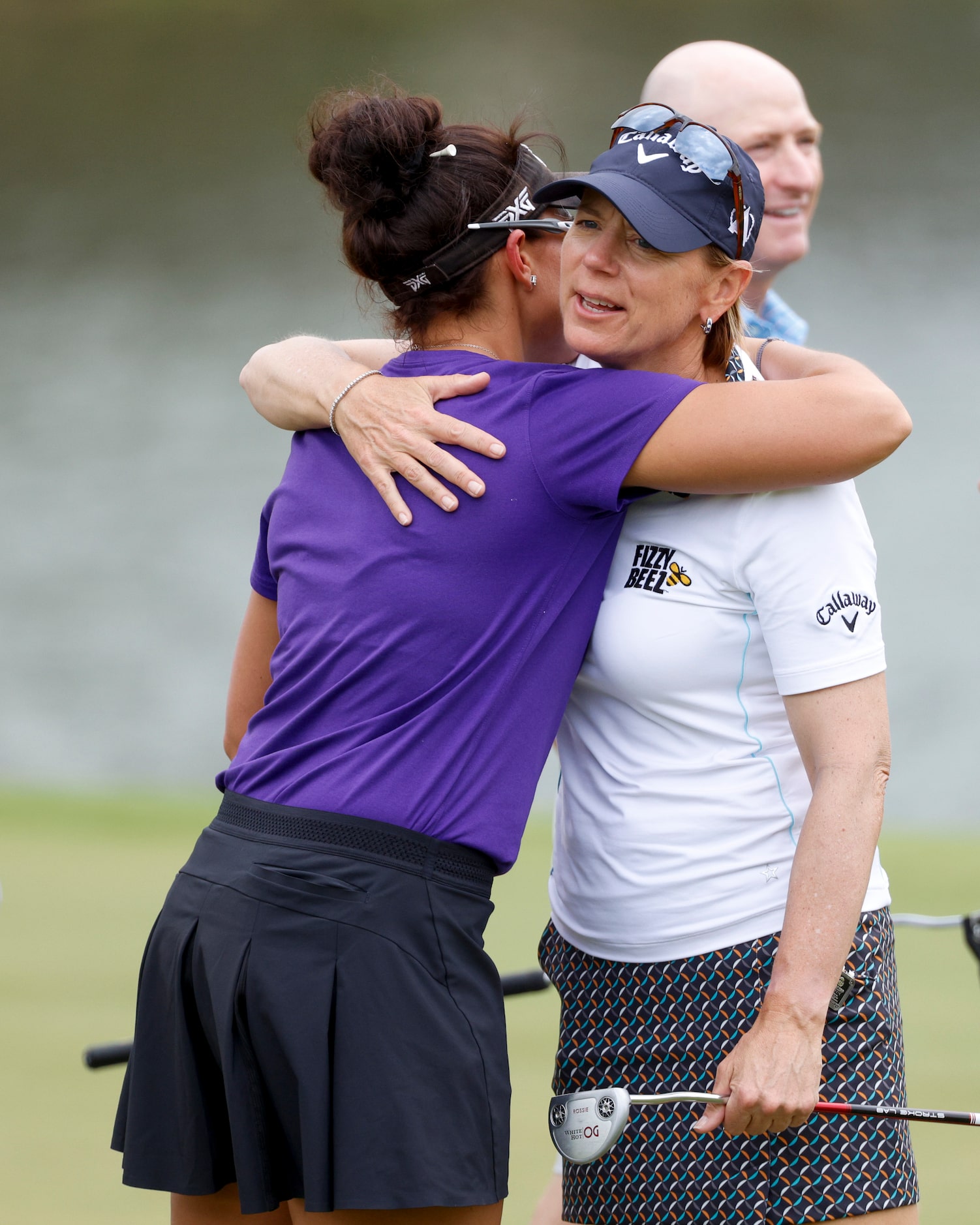 Professional golfer Annika Sorenstam hugs Sydney Youngblood after a round of golf during the...