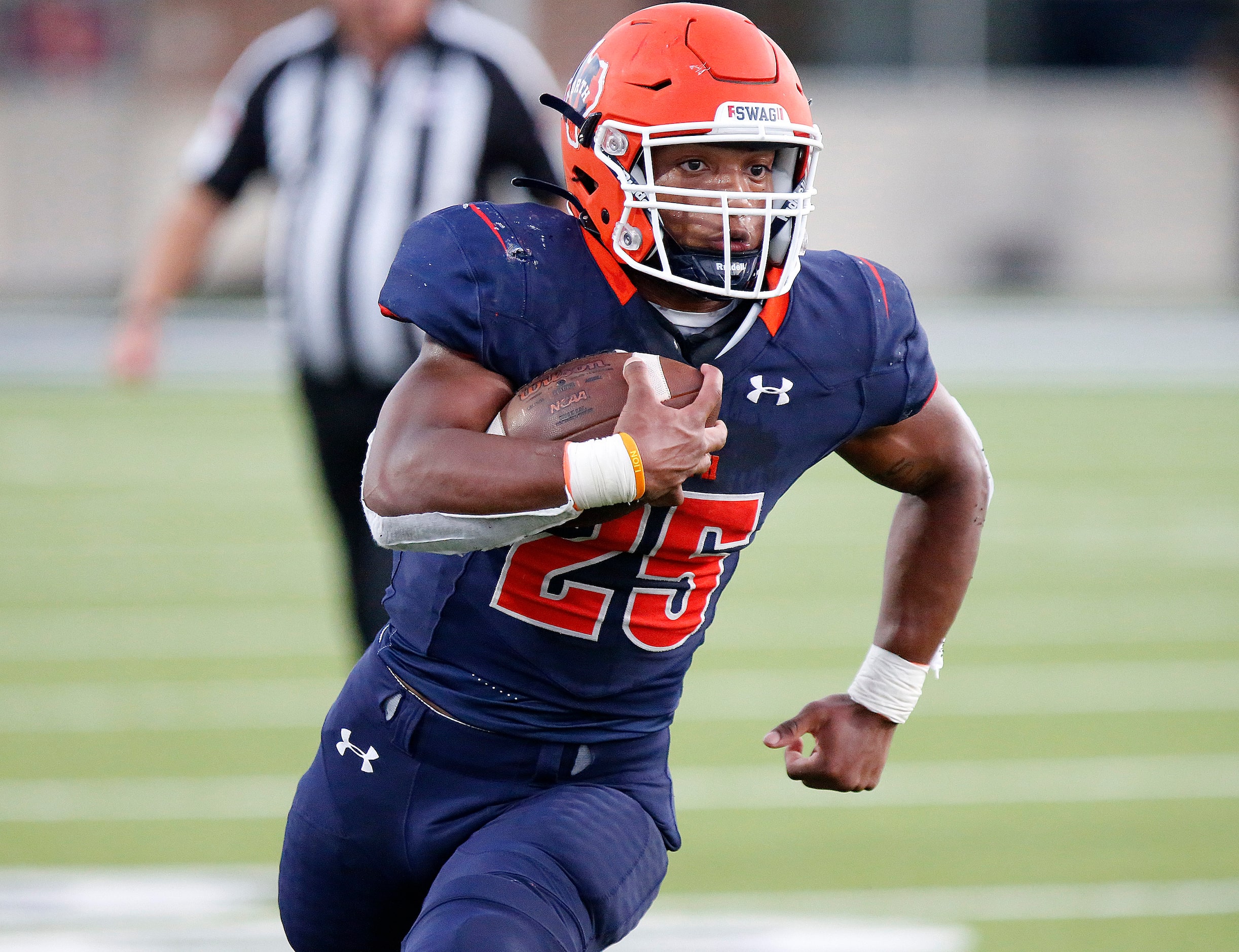 McKinney North High School running back Jadan Smith (25) turns the corner and heads upfield...