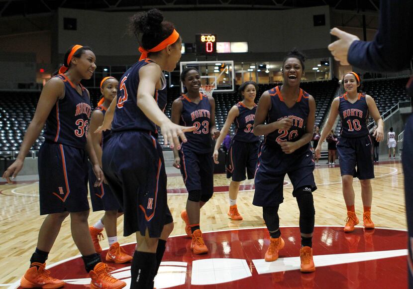 McKinney North guard London Holland (20) leads her team in a celebration after winning the...