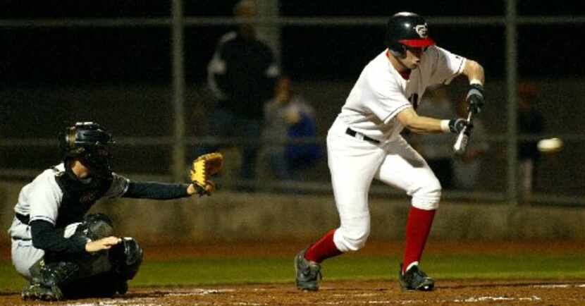 03/30/04 - Coppell High School baseball player Corey Kluber (8) bunts while Mansfield Summit...