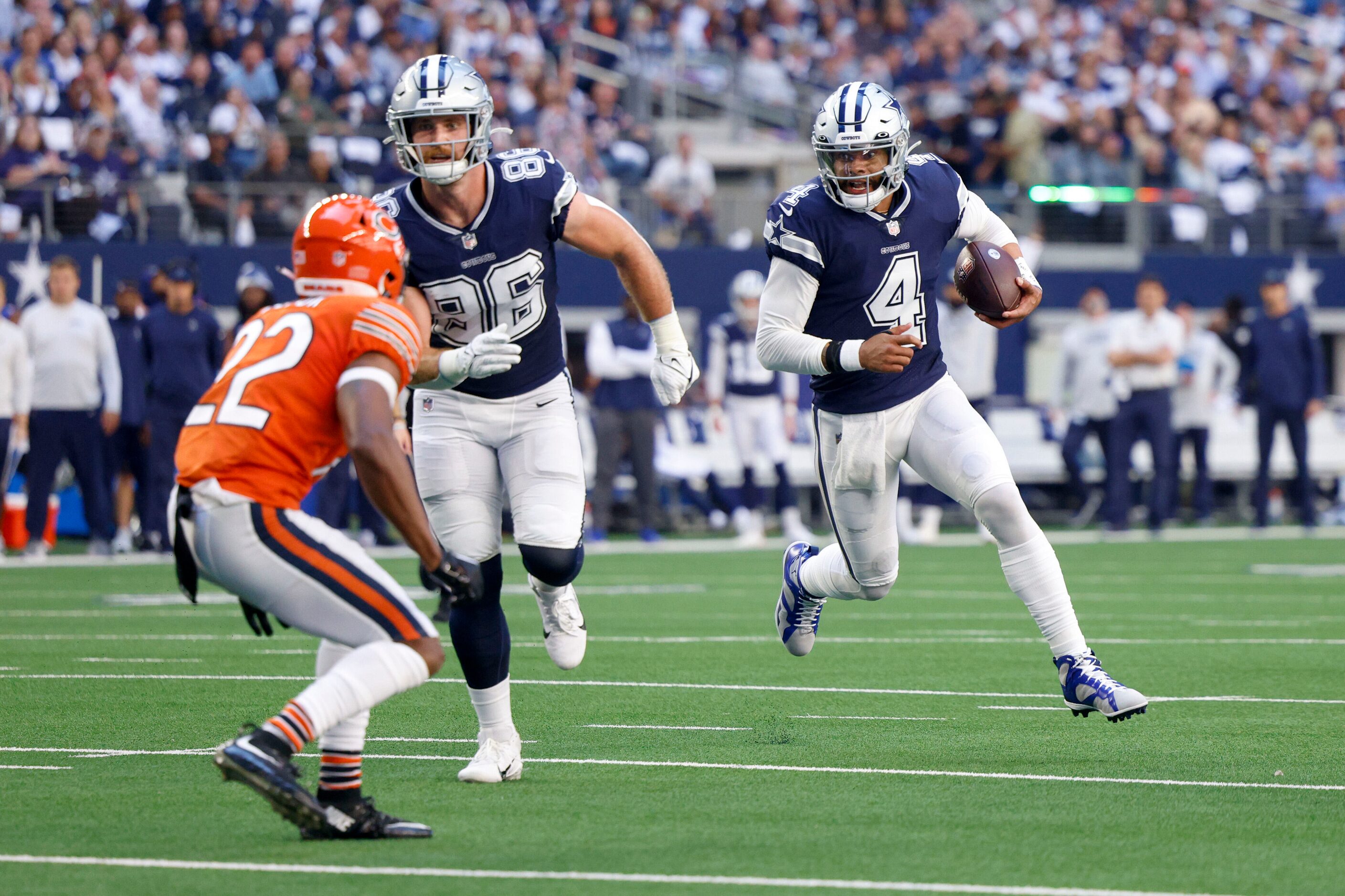 Dallas Cowboys quarterback Dak Prescott (4) runs for a touchdown as tight end Dalton Schultz...