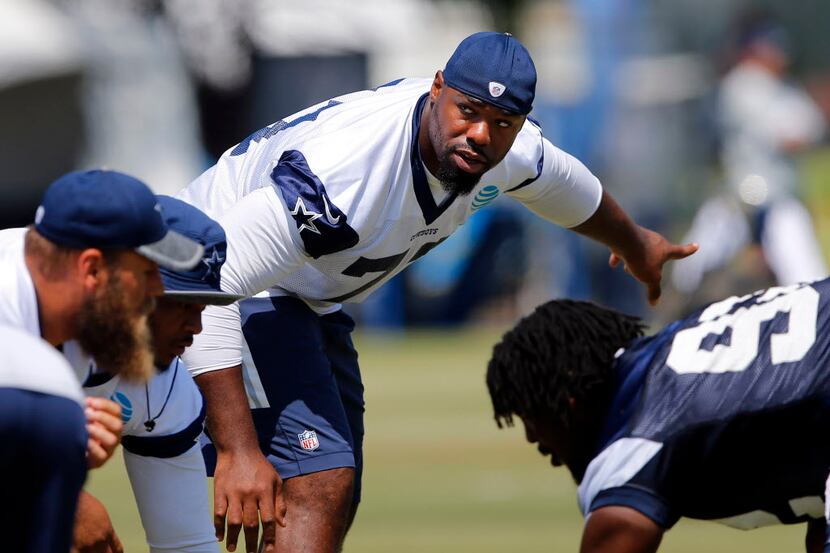 Dallas Cowboys tackle Tyron Smith (77) waits for the snap as he lines up during morning...