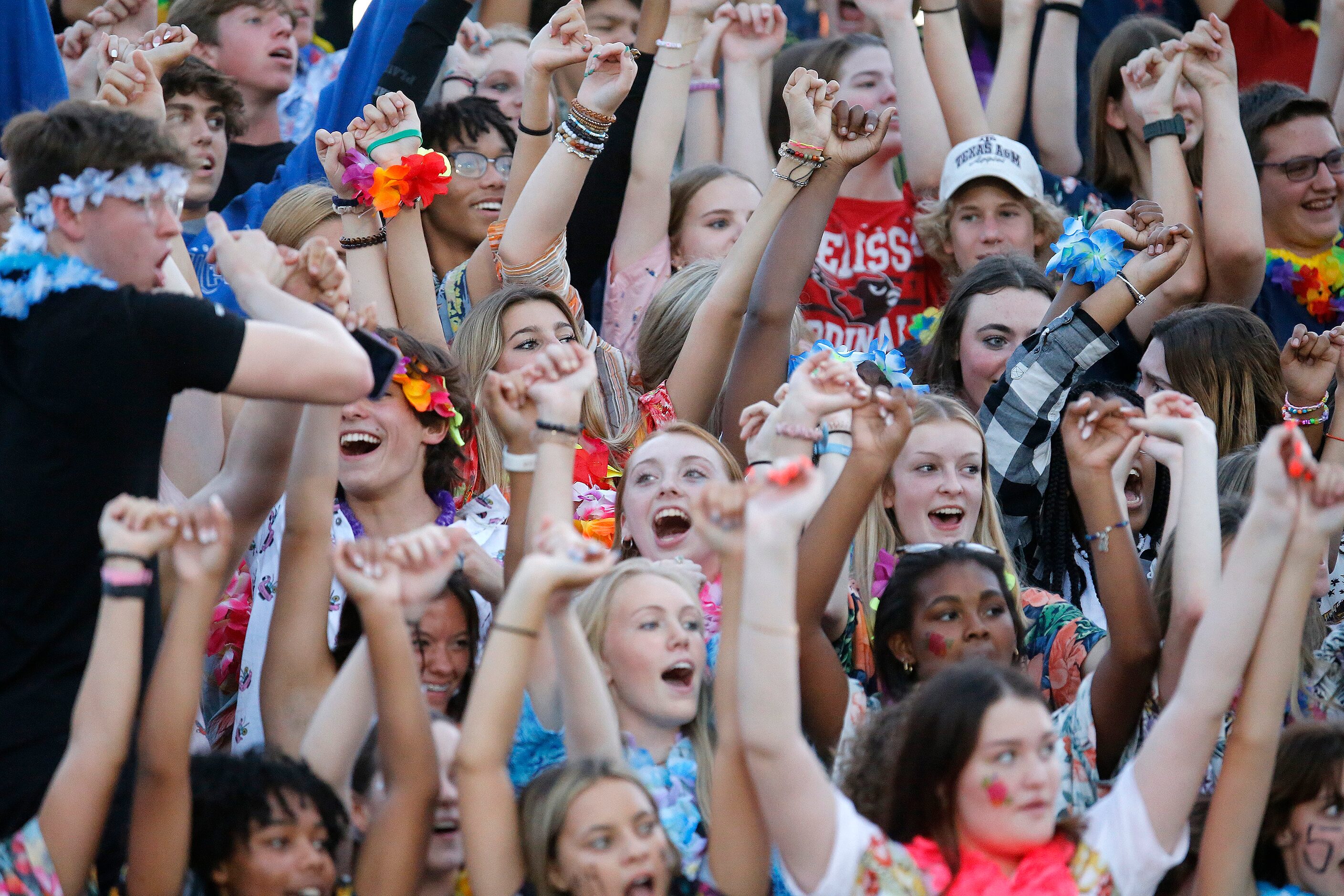 The Melissa High School student section braces for a kickoff after scoring a touchdown...