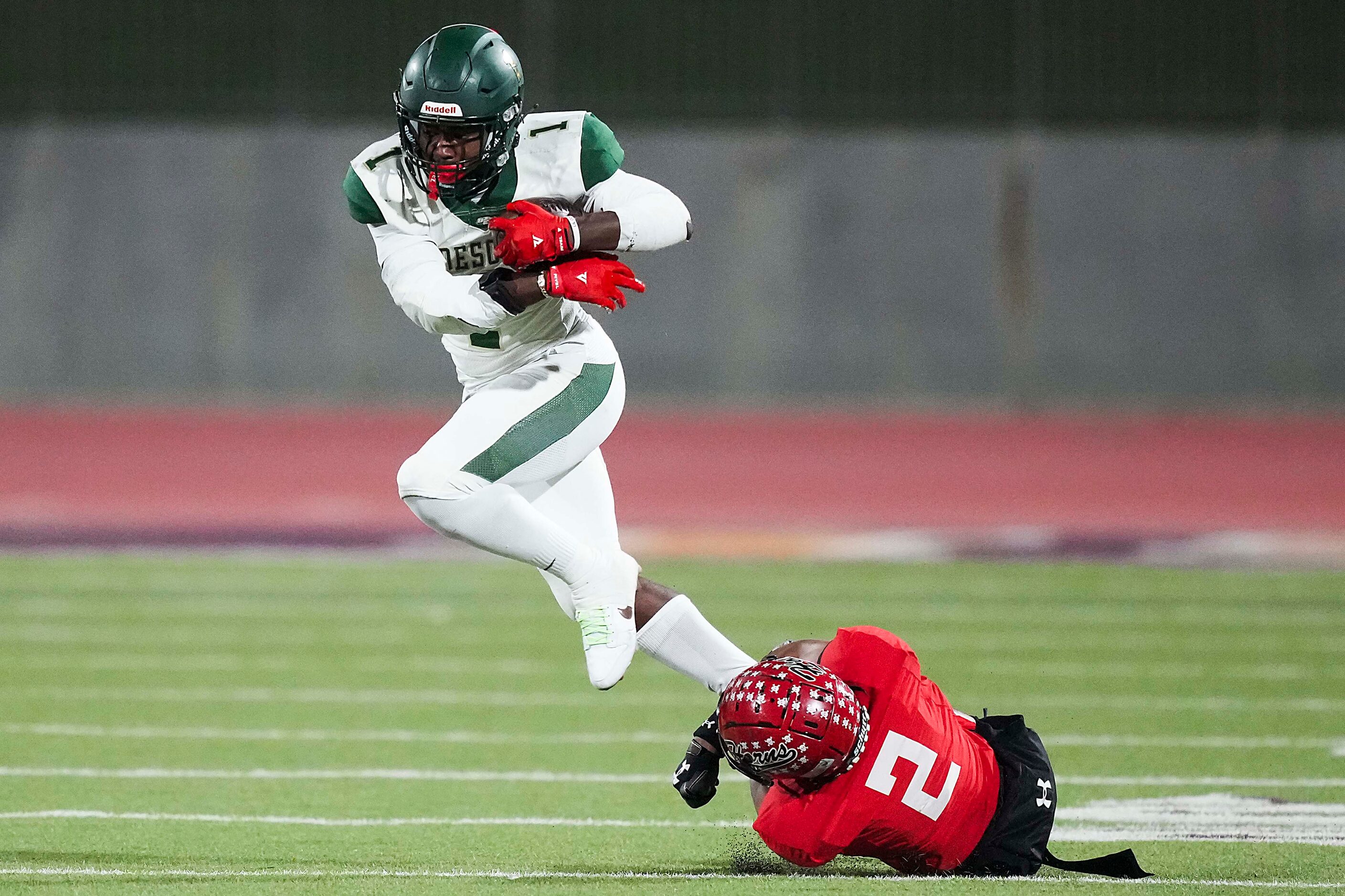 DeSoto running back Deondrae Riden Jr. (1) slips past Cedar Hill defensive back Dante Wesley...