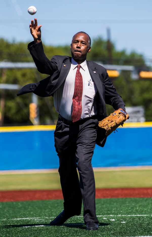 U.S. Secretary of Housing and Urban Development Ben Carson throws the first pitch for a...