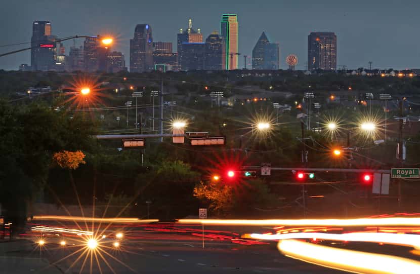 Traffic zips by a view of the Dallas skyline from north of Royal Lane and Abrams Road in...