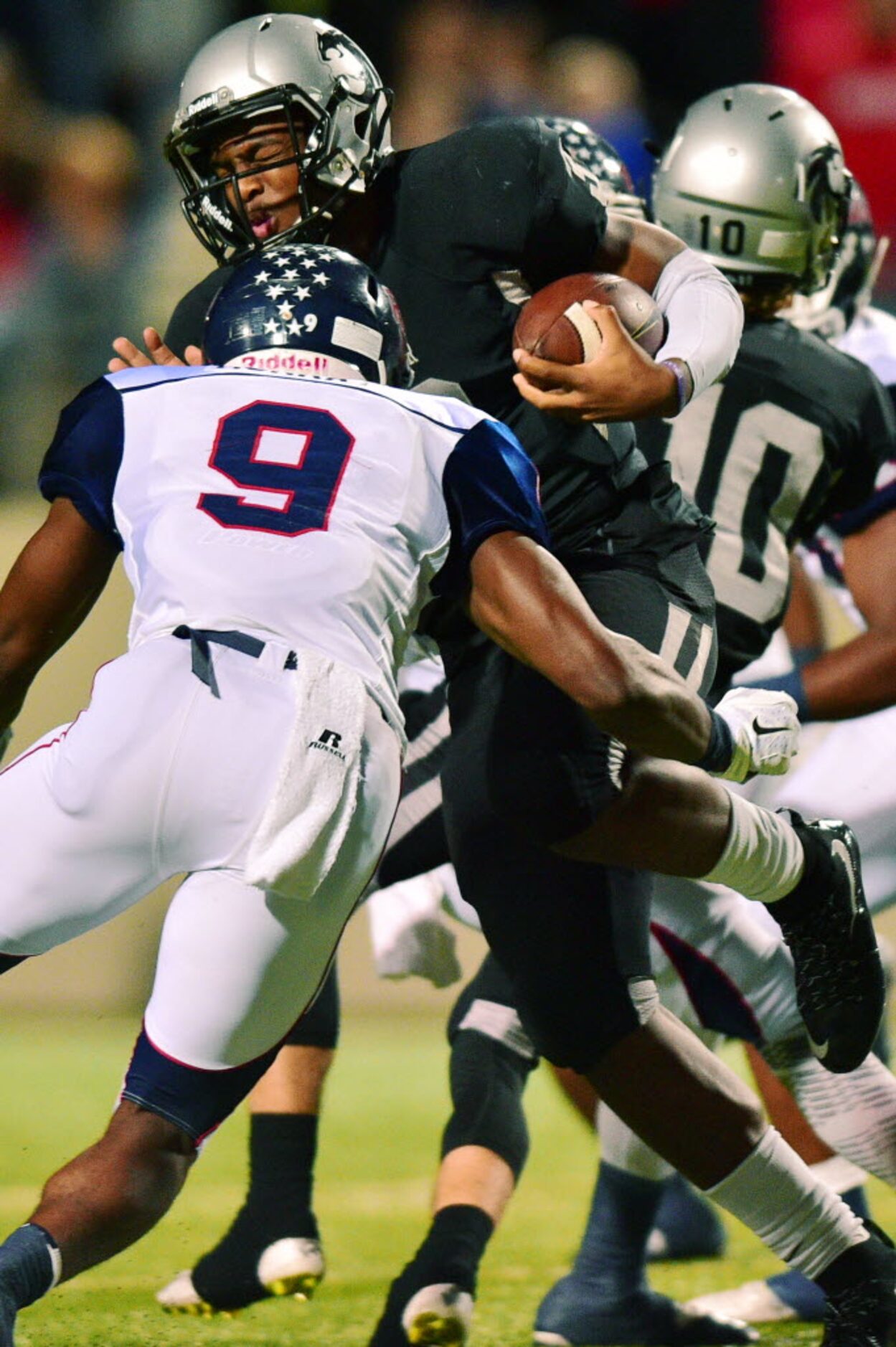 Guyer junior quarterback Shawn Robinson (3) is slammed by Ryan junior defensive end Kaelin...