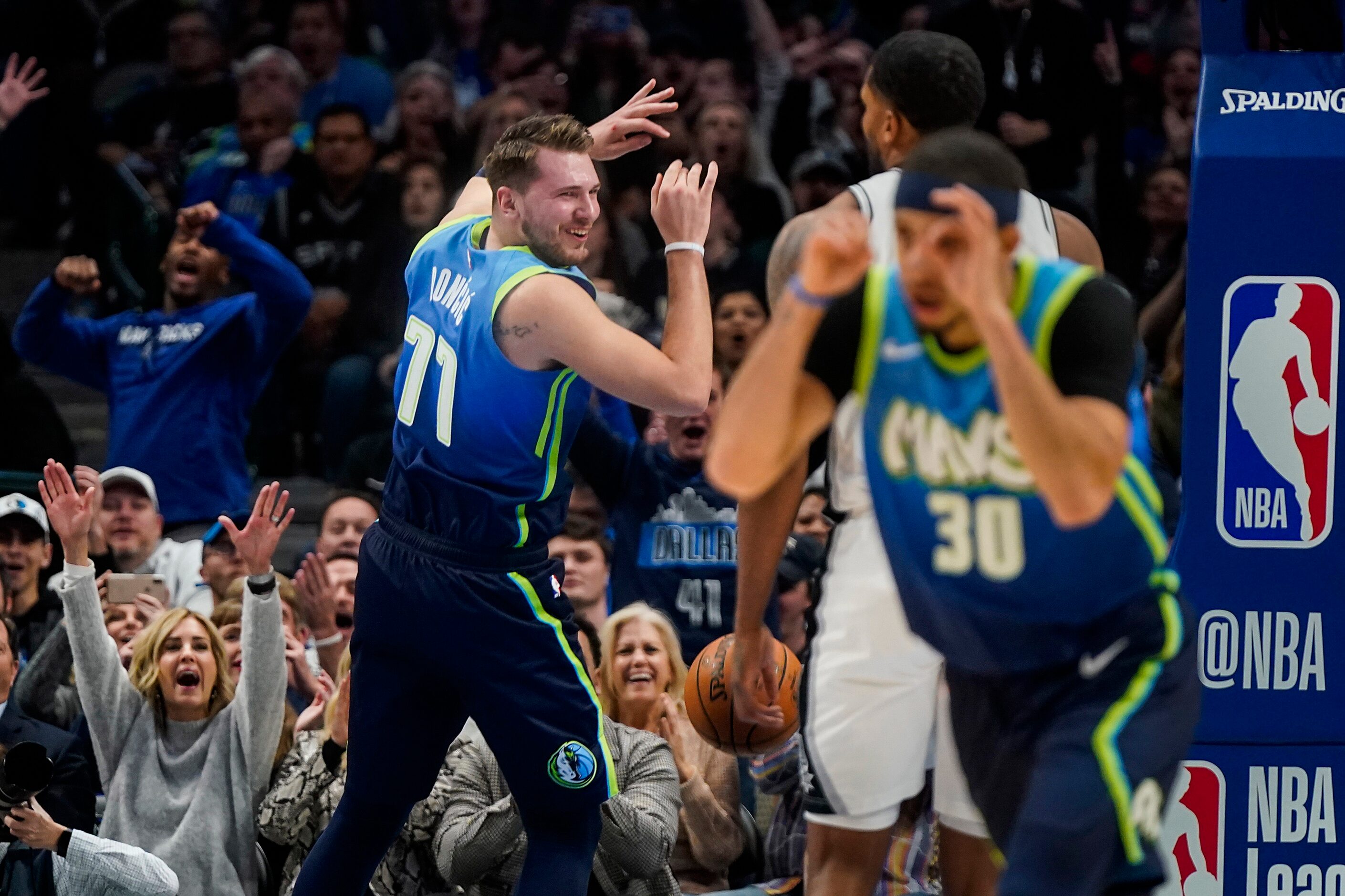 Dallas Mavericks guard Luka Doncic (77) celebrates after dunking the ball past San Antonio...