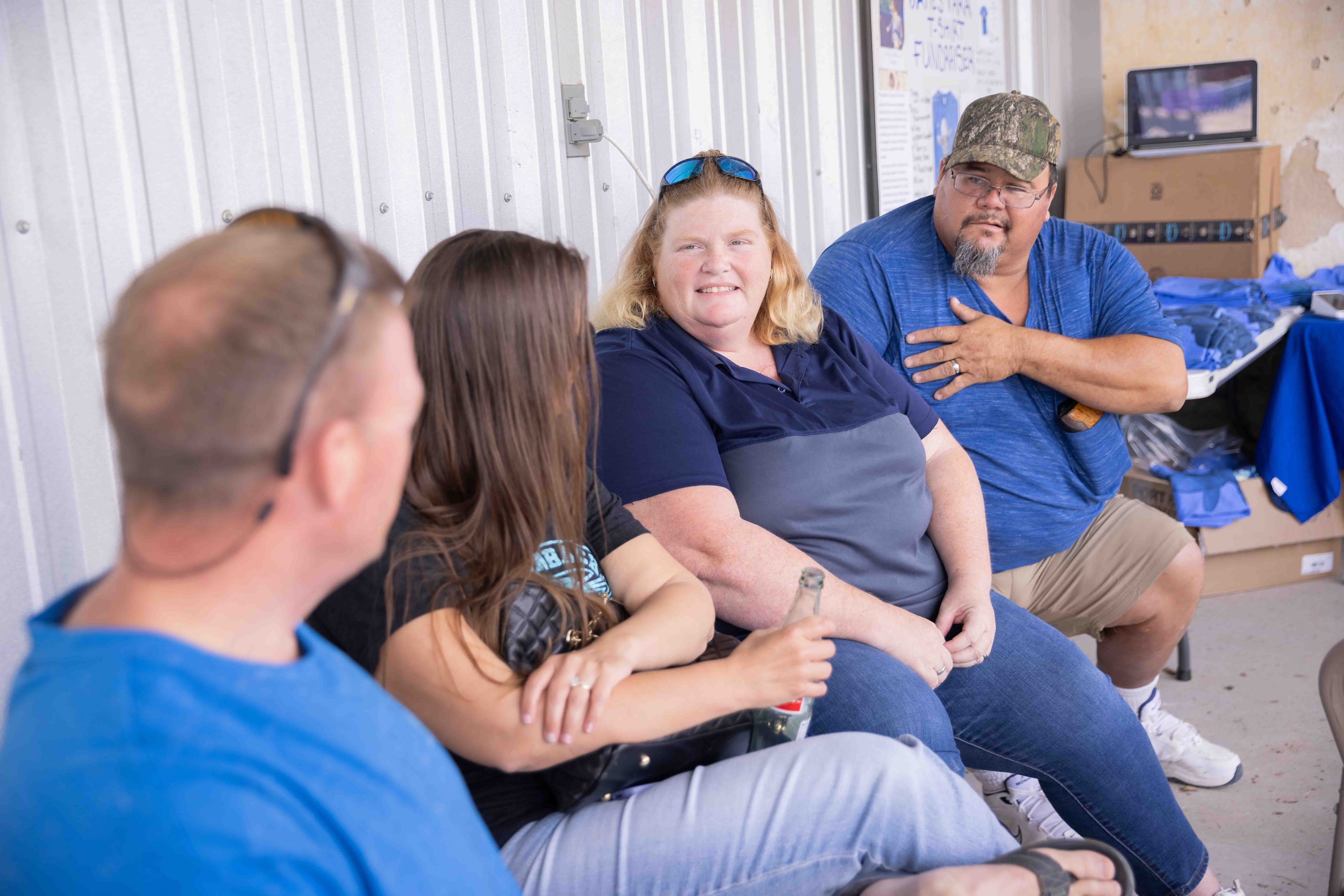 Venus Vara (second to right) and James Vara Sr., parents of James Vara Jr., chat as the...