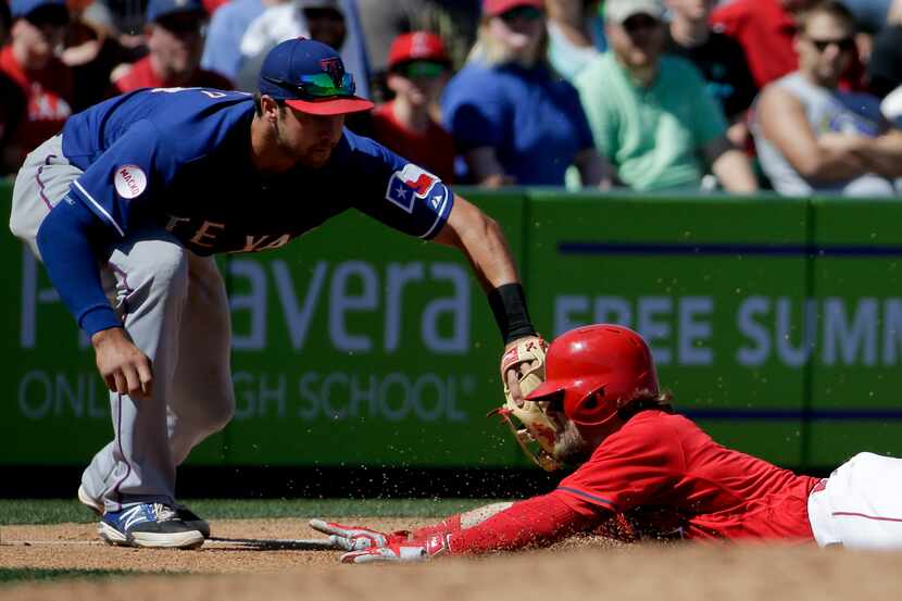 Texas Rangers third baseman Joey Gallo, left, tags Los Angeles Angels' Collin Cowgill out at...