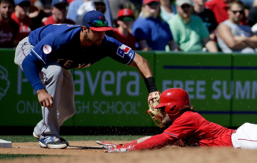 Texas Rangers third baseman Joey Gallo, left, tags Los Angeles Angels' Collin Cowgill out at...