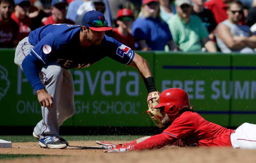 Texas Rangers third baseman Joey Gallo, left, tags Los Angeles Angels' Collin Cowgill out at...