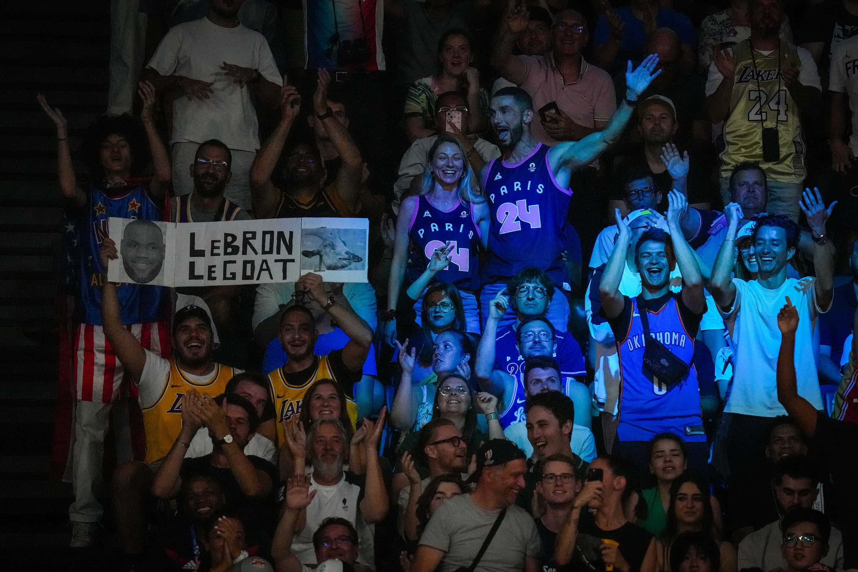 Fans cheer for the United States during a men’s basketball quarterfinal against Brazil at...