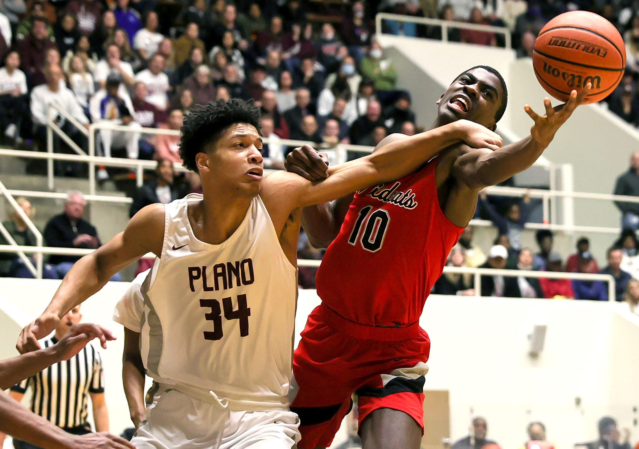 Lake Highland center Samson Aletan (10) gets fouled on a rebound by Plano forward Kaden...