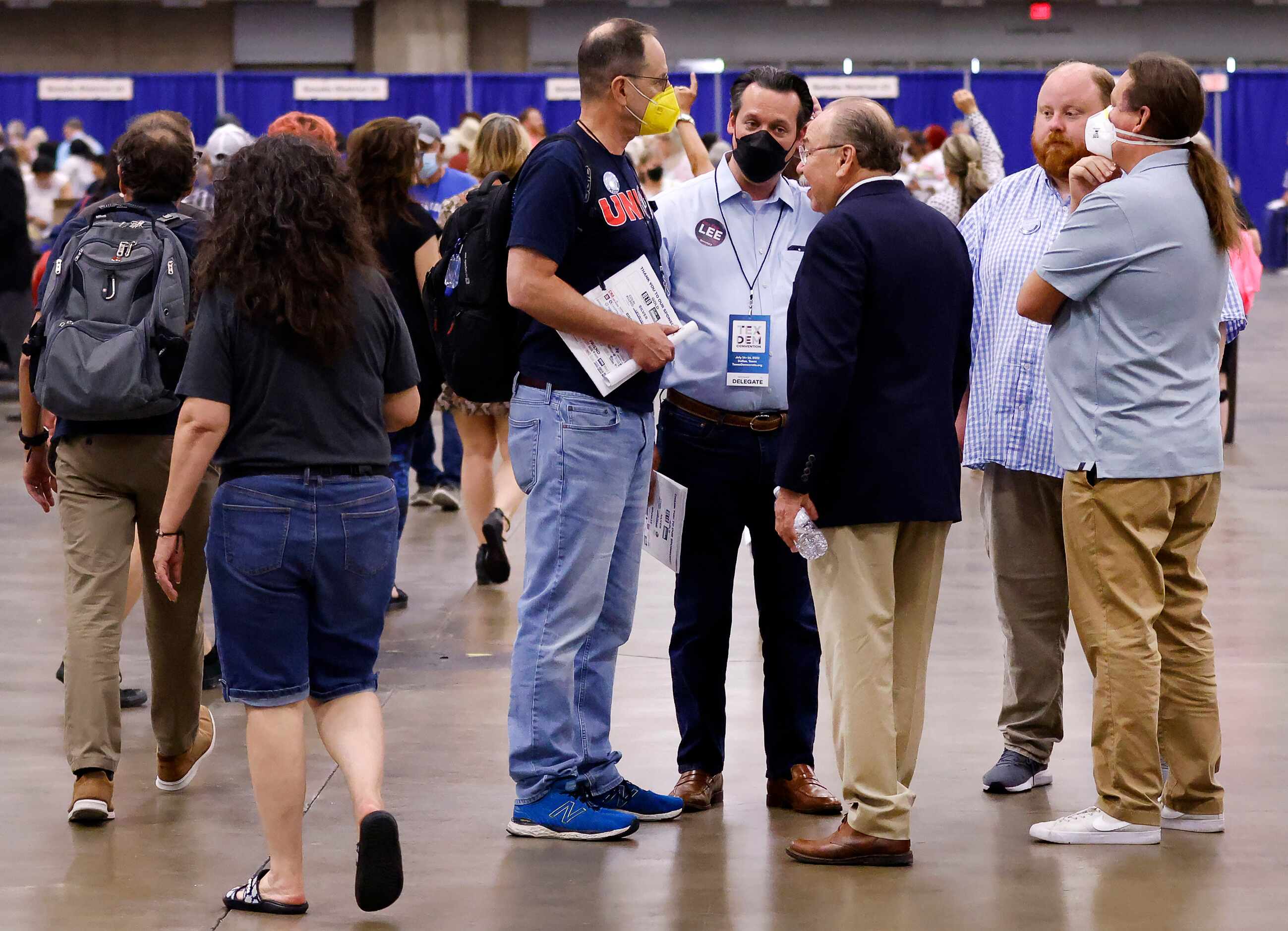 Texas Democratic Party Chairman Gilberto Hinojosa (third from right) visits with delegates...