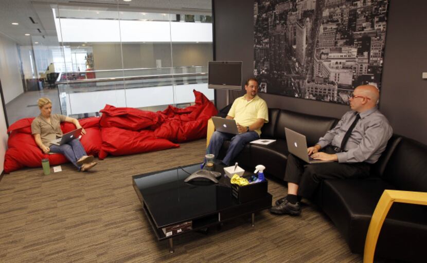 Marketing manager Adrienne Thomas (left) talks with Darin Newbold and Chris Koeberle in a...