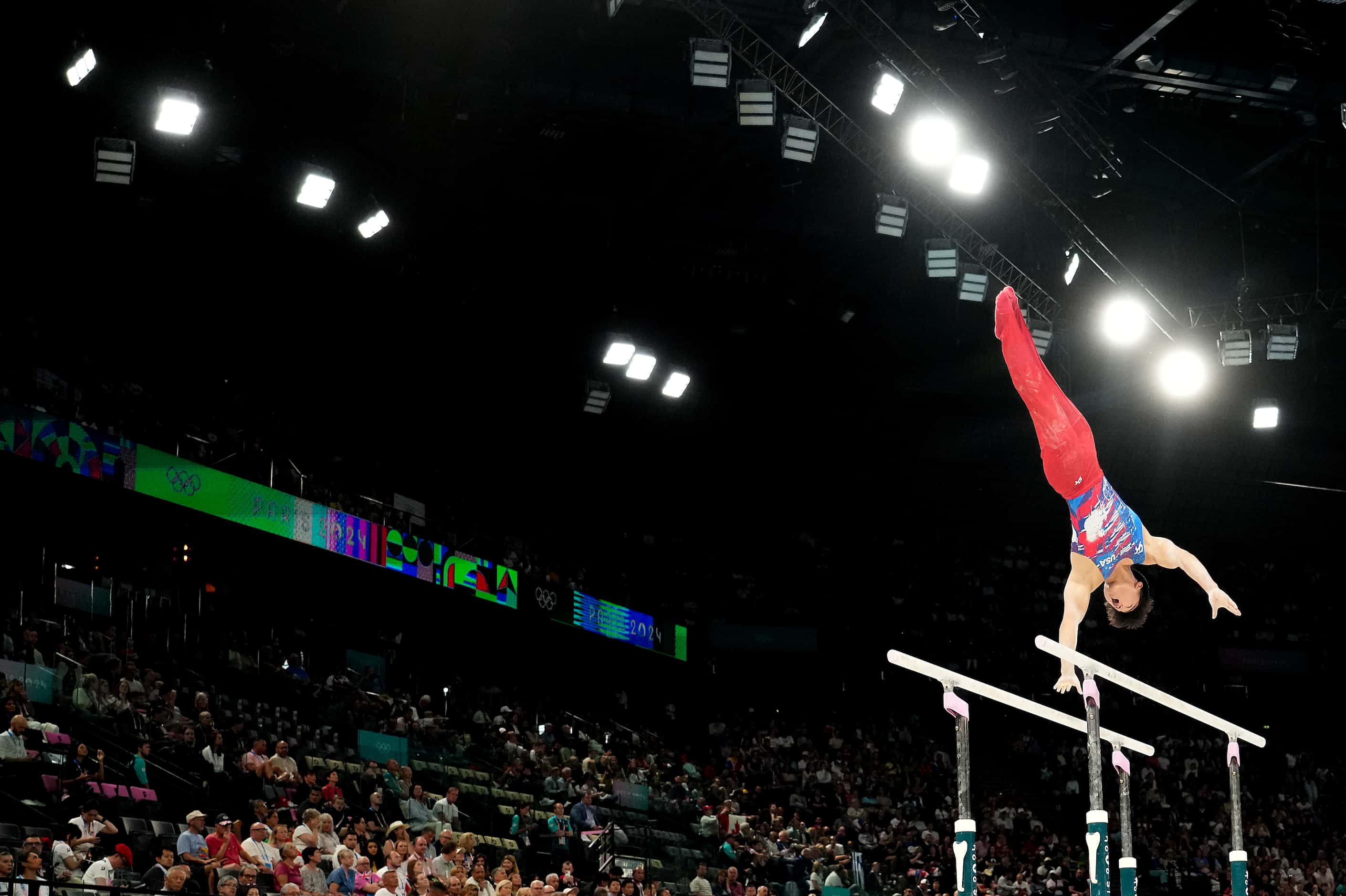 Paul Juda of the United States competes on the parallel bars during men’s gymnastics...