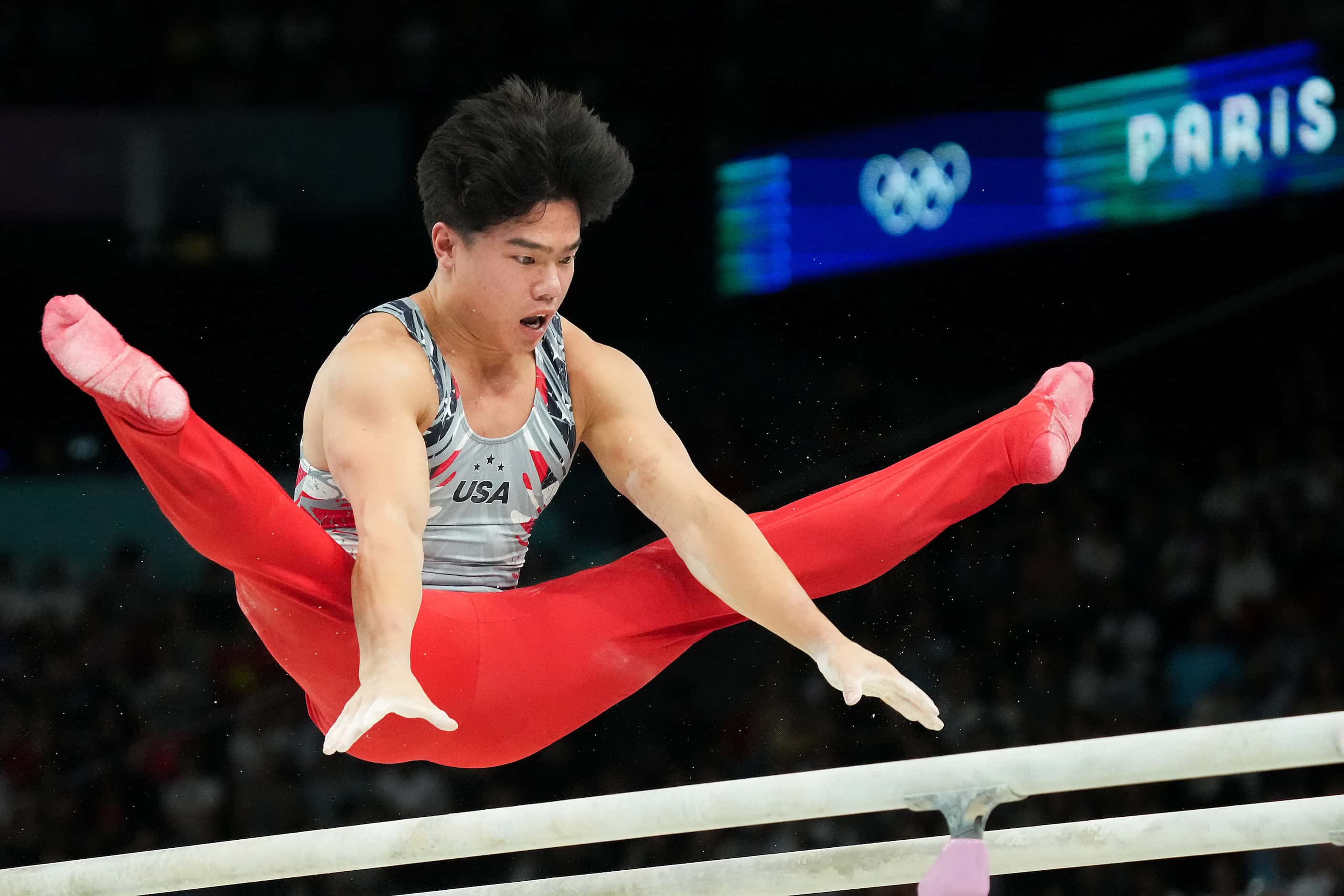 Asher Hong of the United States competes on the parallel bars during the men’s gymnastics...