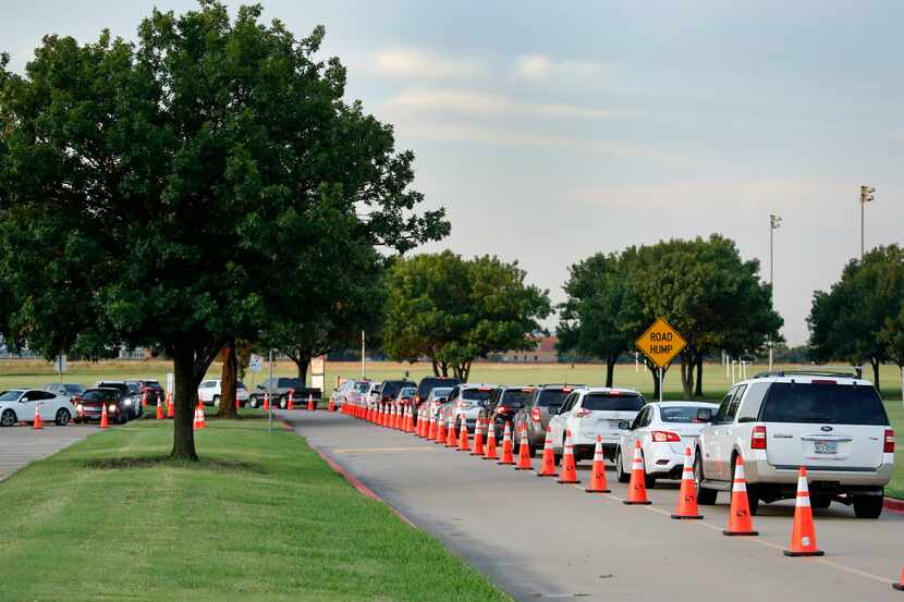 A line of drivers wait to have a nasal swab test in a drive-through COVID-19 testing site at...