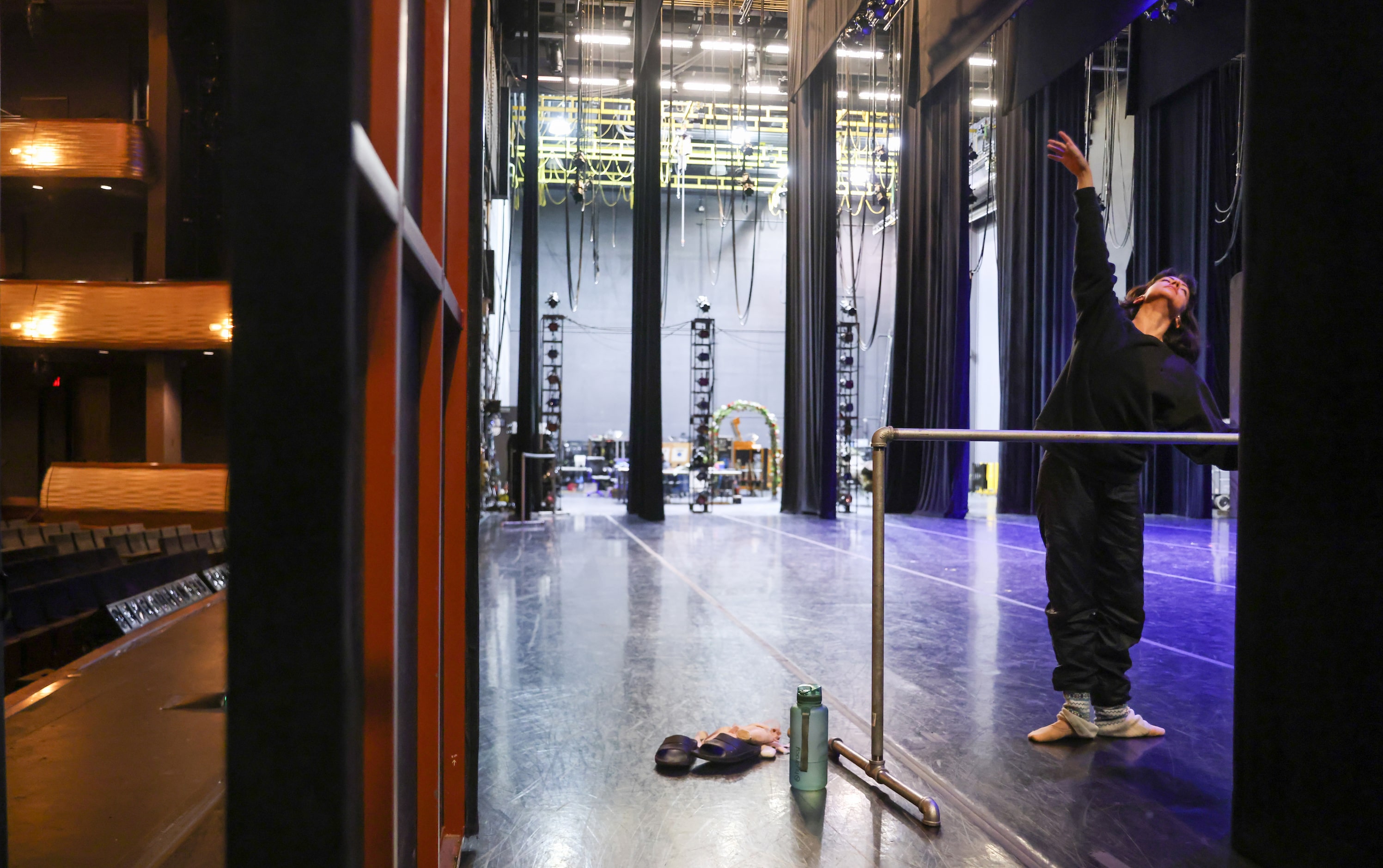 Alexandra F. Light warms up on an empty stage for her role as Alice in a dress rehearsal of...