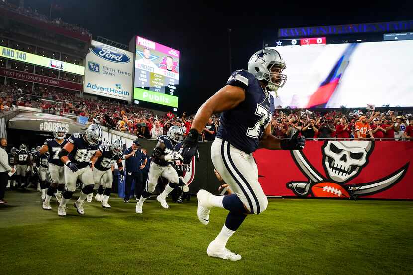 Dallas Cowboys offensive tackle La'el Collins (71) leads teammates onto the field before an...