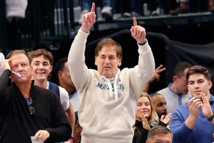Former Dallas Mavericks owner Mark Cuban, center, declined to comment on speculation he...