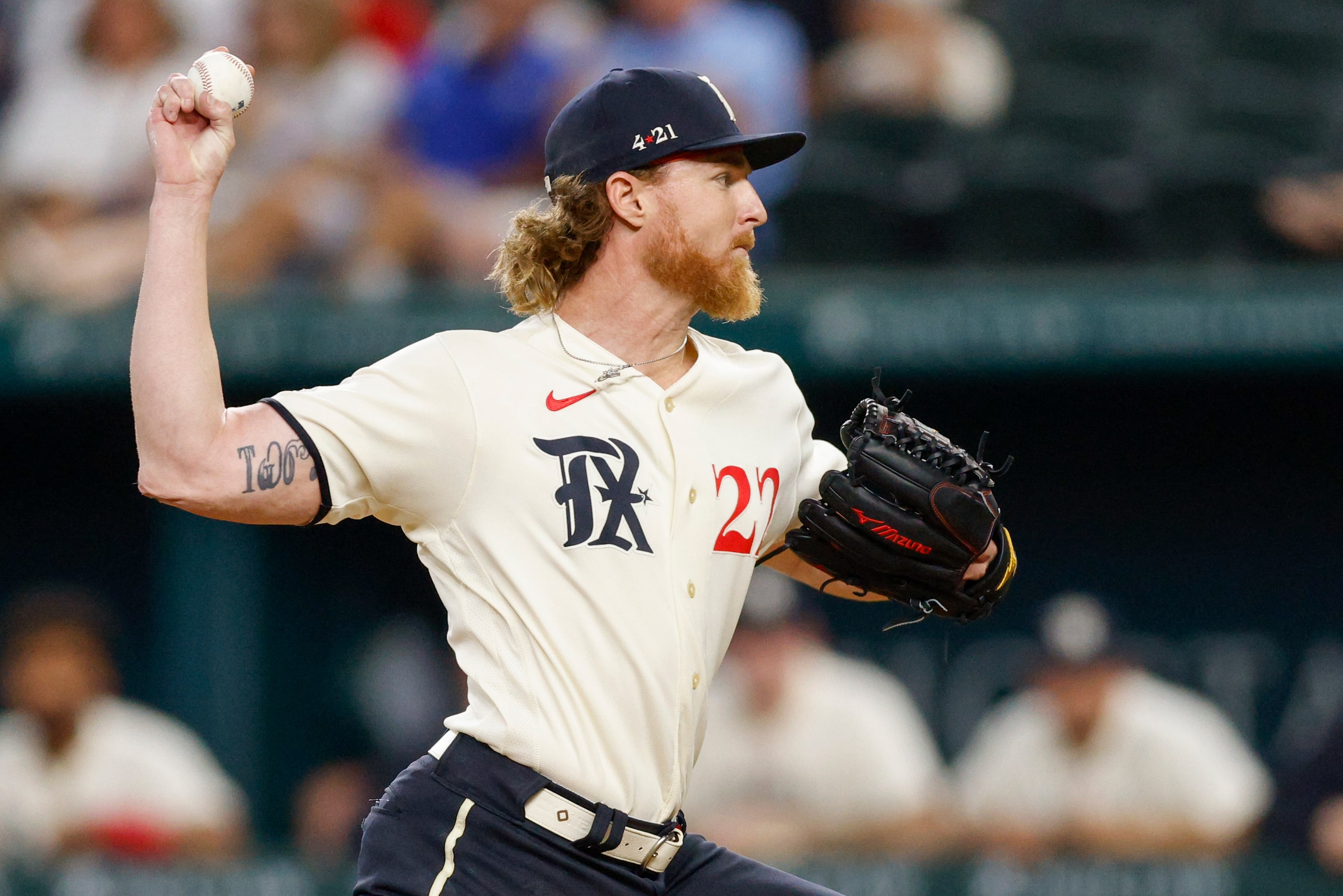 Texas Rangers starting pitcher Jon Gray (22) delivers a pitch during the first inning of a...