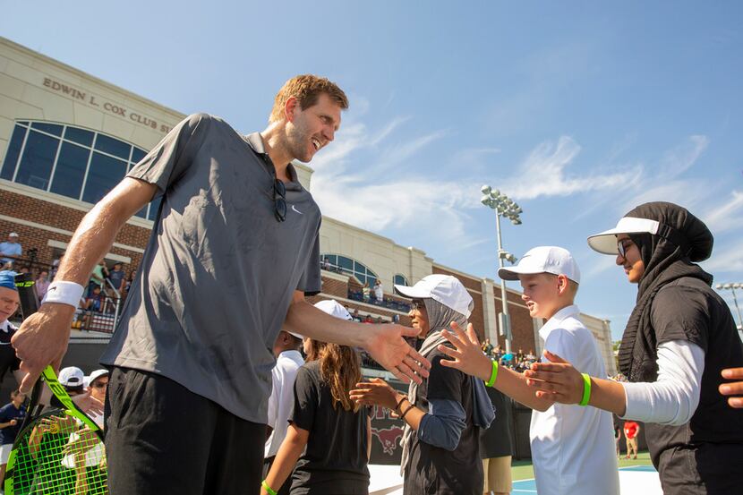 Dirk Nowitzki gives ball kids high-fives before starting The Dirk Nowitzki Pro Celebrity...