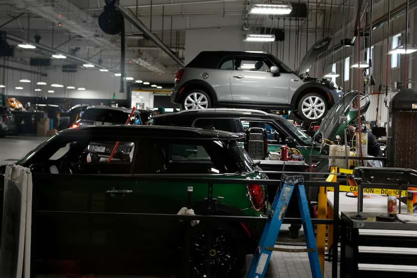 FILE - Cooper models are tended to in the service bay of a Mini dealership Nov. 3, 2022, in...