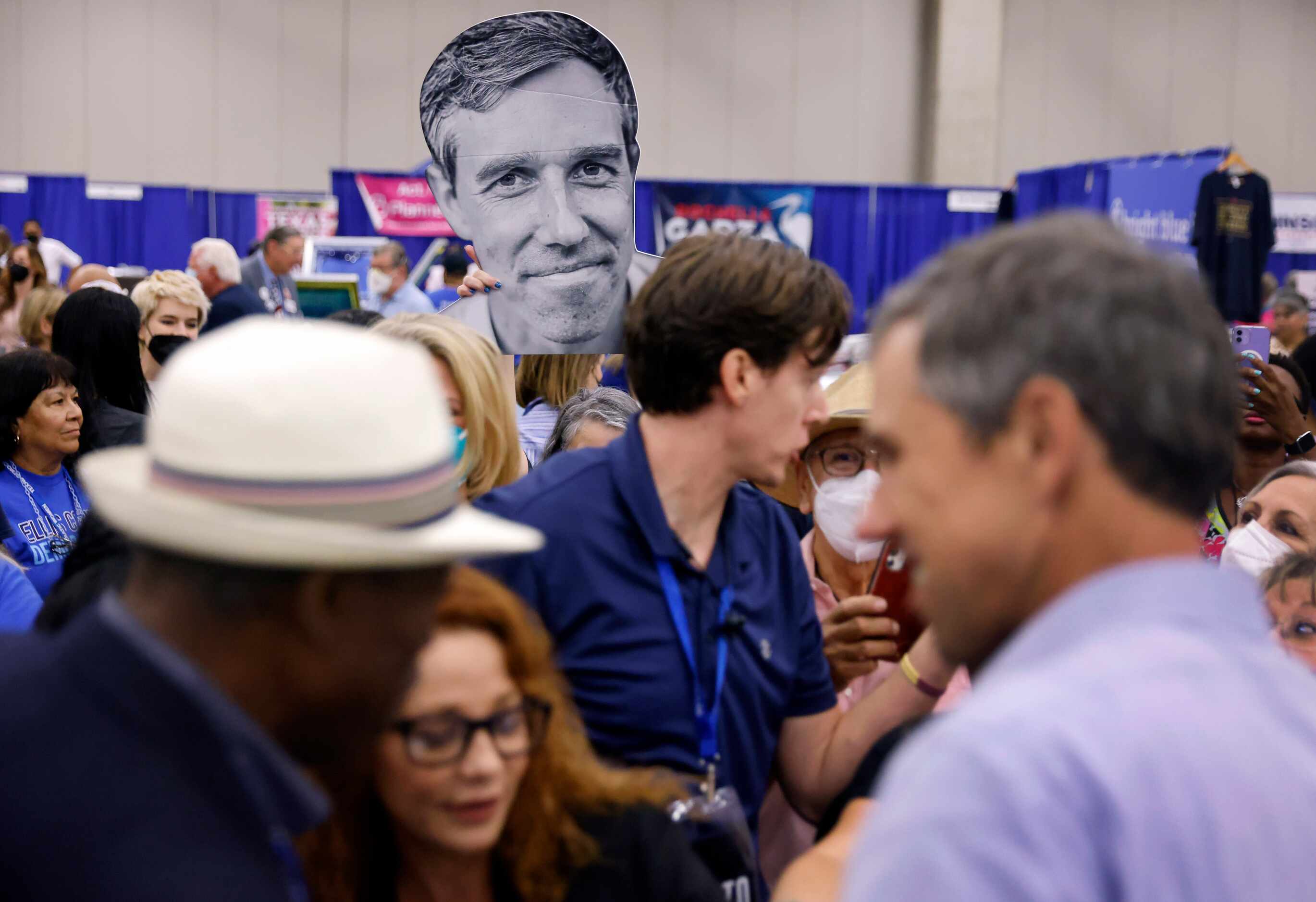 A cutout of Democratic gubernatorial challenger Beto O'Rourke rises above the crowd gathered...