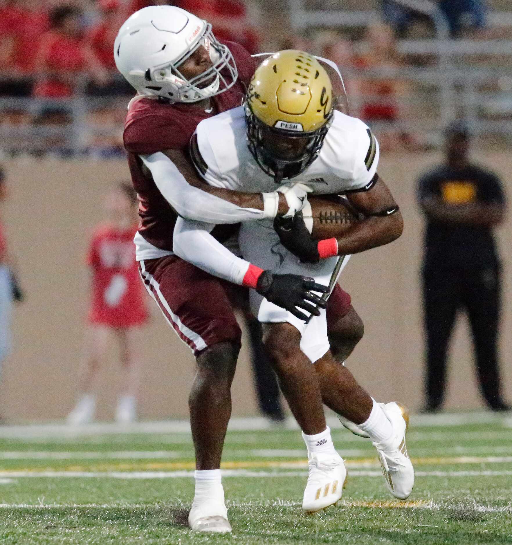 Plano Senior High School defensive back Daniel Bennett (11) tackles Plano East High School...