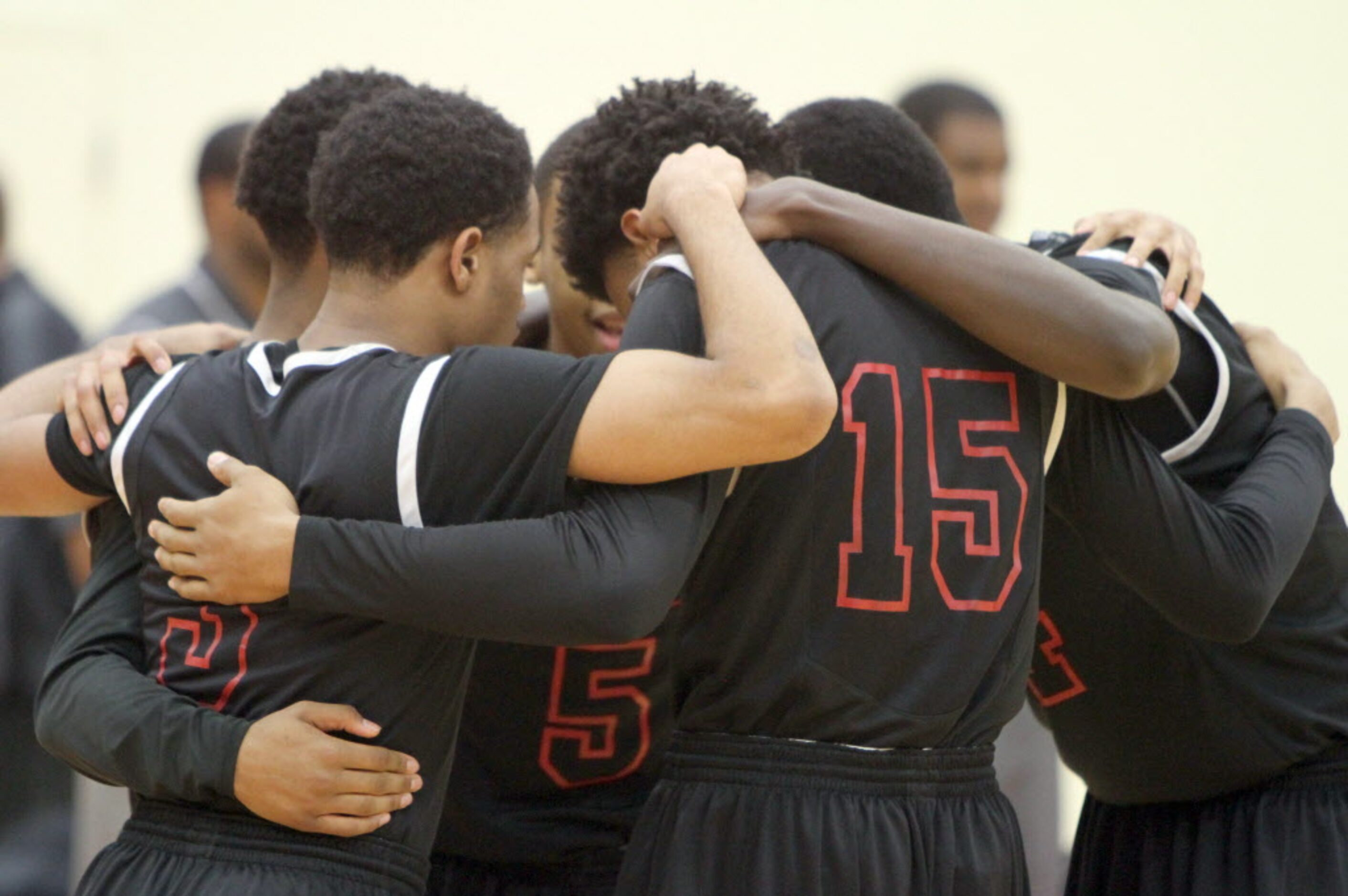 Members of the Cedar Hill Longhorns huddle in front of the team bench just before the...