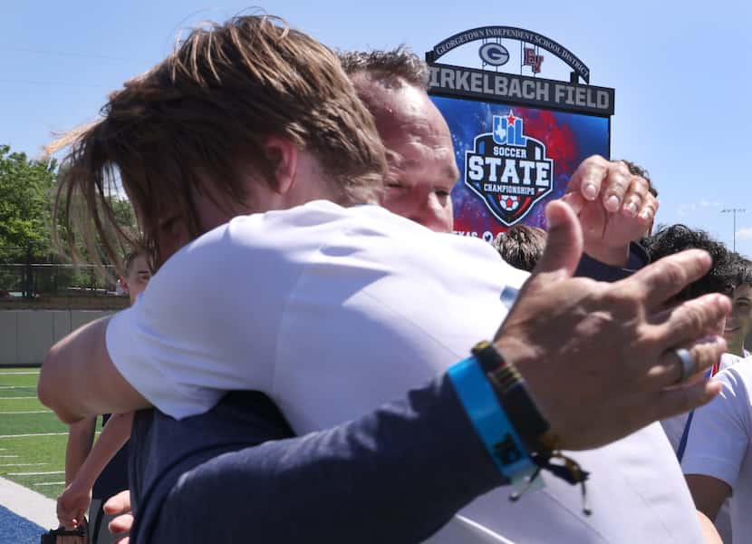 Frisco Lone Star head coach Clinton Hollingsworth shares a hug with senior defender Jacob...